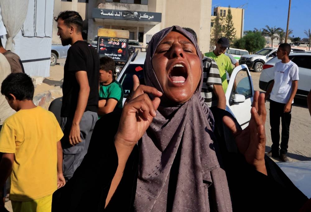 People mourn Palestinians who were killed in an incident on Wednesday while seeking aid in Khan Younis, at Nasser hospital in Khan Younis in the southern Gaza Strip. REUTERS