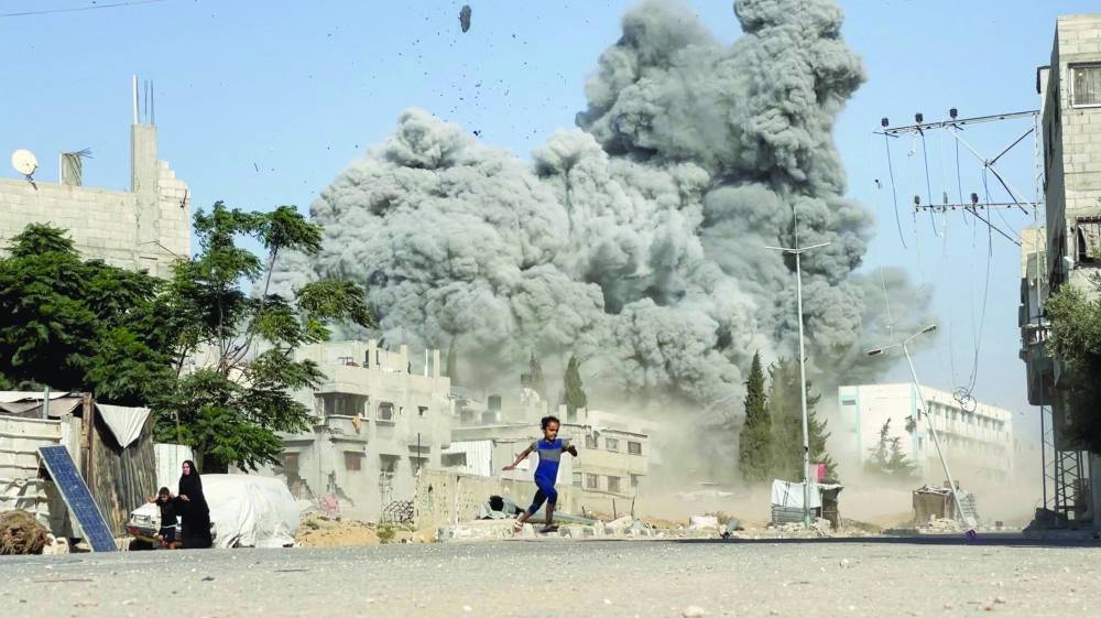 A girl runs from the scene after Israeli strikes on a school sheltering displaced people at the Bureij refugee camp in the central Gaza Strip.