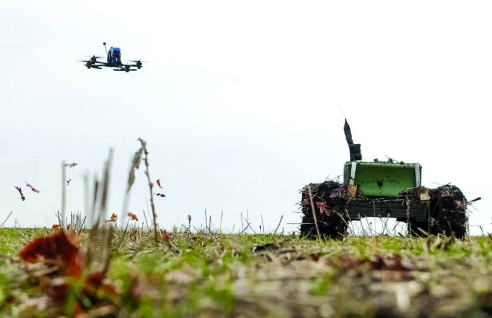 
An unmanned ground vehicle with a landmine installed on it and a first person view (FPV) drone operate in Kharkiv region in January this year. (Reuters) 