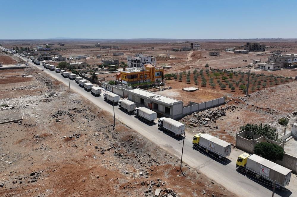 An aerial picture shows a Syrian Red Crescent convoy carrying humanitarian aid heading to Sweida Sunday 