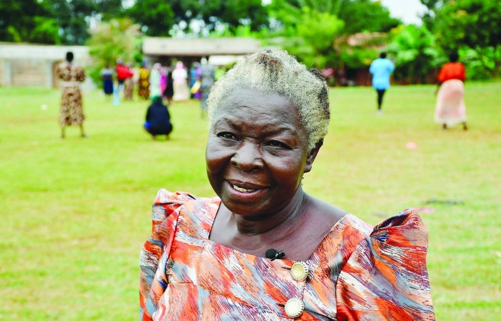 Jane Anonyaalaba, 70, speaks during a Reuters interview as elderly women participate in a community-led fitness drills session that combines yoga, aerobics, and cricket drills to combat non-communicable diseases (NCDs), on a playing field in Kivubuka village, in Jinja District, Eastern Uganda, July 12, 2025. REUTERS/Abubaker Lubowa