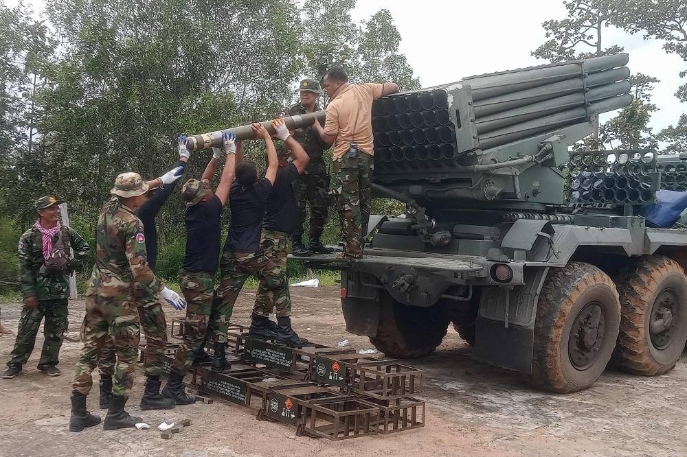 Cambodian soldiers reload the BM-21 multiple rocket launcher in Preah Vihear province yesterday.