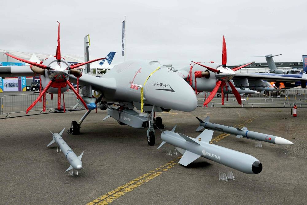 (FILES) This photograph shows a Baykar Bayraktar Ak?nc? drone aircraft presented by Turkish defence company Baykar Defense displayed during the 55th edition of the International Paris Air Show (Salon international de l'aeronautique et de l'espace - SIAE) at the Paris豊e Bourget Airport, in Le Bourget, suburb of Paris on June 15, 2025. Low-cost technologies -- ubiquitous in current conflicts particularly in Ukraine -- and remotely piloted reconnaissance and strike aircraft are generating massive interest in Africa. Ethiopia and many other African nations are now turning to drones as a low-cost means of waging war with mixed military results but devastating consequences for civilian populations. (Photo by Thomas SAMSON / AFP)