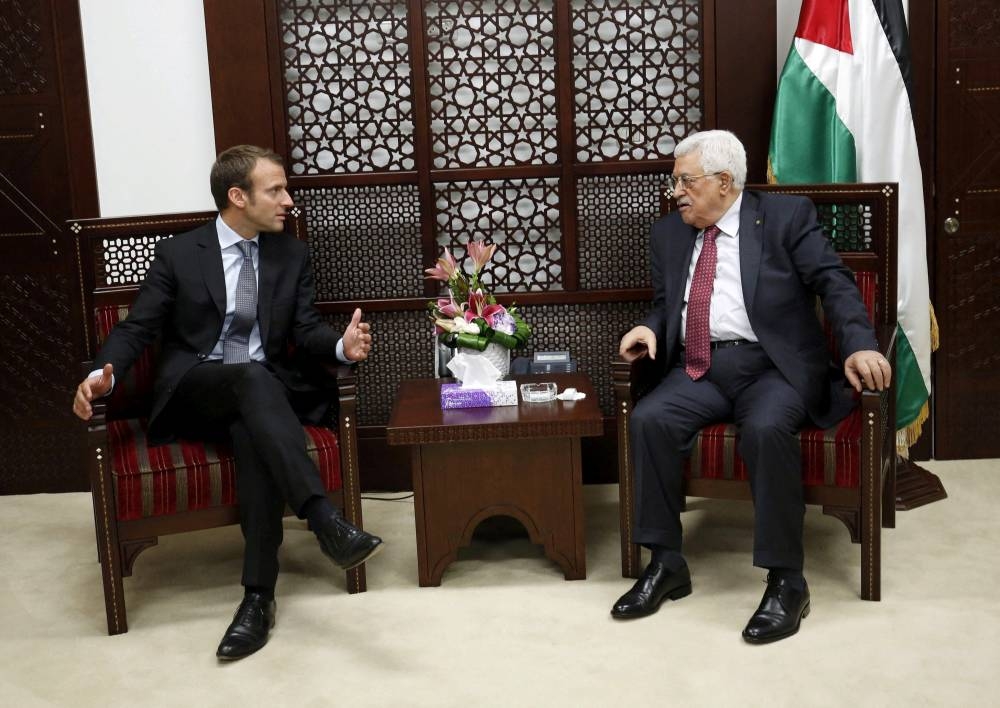 Palestinian President Mahmoud Abbas (right) meets with the-then French Economy Minister Emmanuel Macron in the West Bank city of Ramallah September 7, 2015. (Reuters)