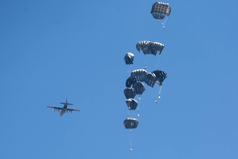 An aircraft drops humanitarian aid over the northern Gaza Strip yesterday.
