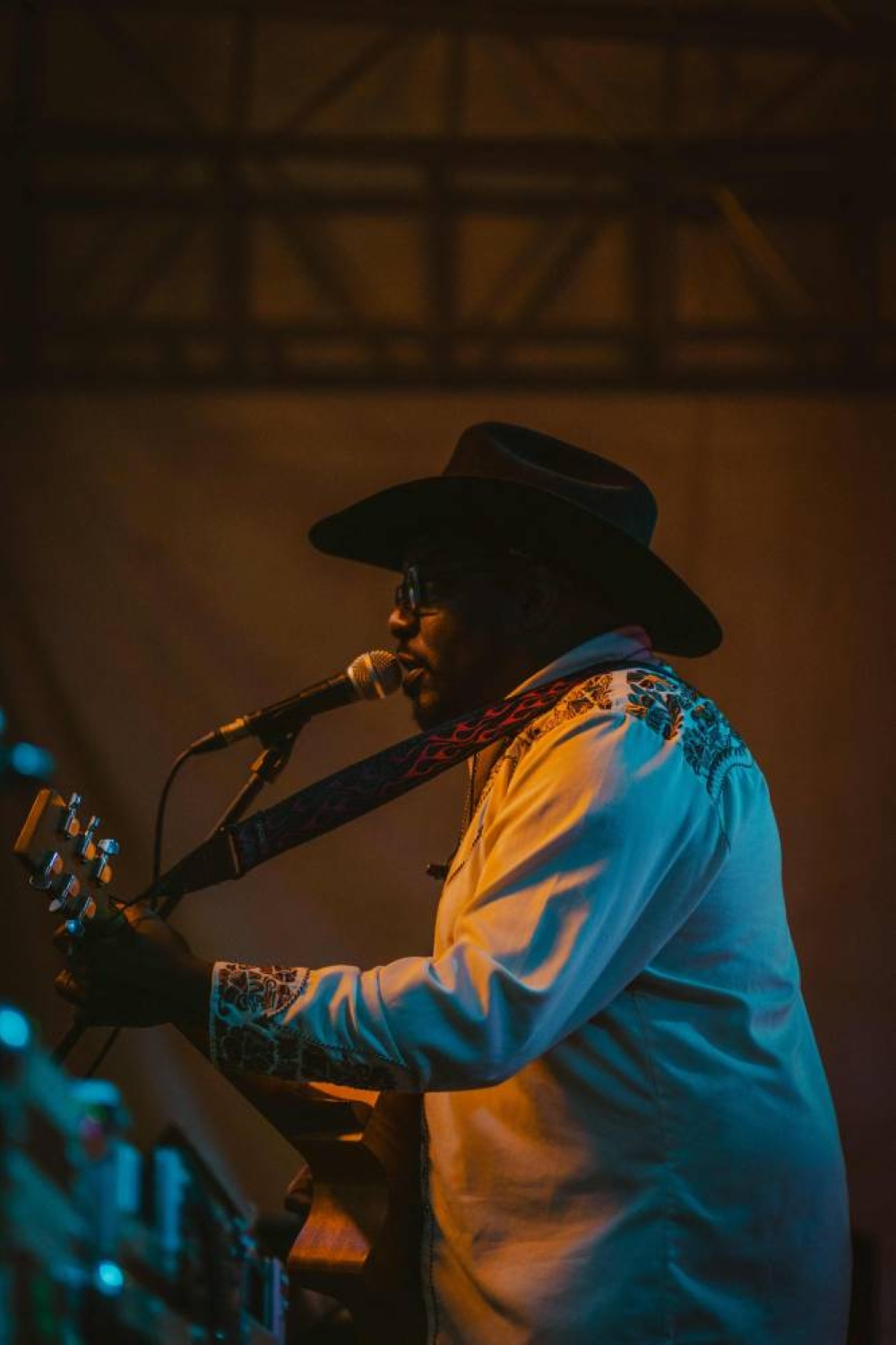 Kenyan Country artist Sir Elvis and the Urban Cowboys perform during the International Cowboy Day at Ngong race course in Nairobi on July 26, 2025. Country music have a loyal fan base in Kenya and the popularity of the music continuing to grow, the event was celebrated by hundreds of attendees with a collective of country artists performing.  The headline of the event was Sir Elvis, Kenya's biggest country star. (Photo by Fredrik Lerneryd / AFP)