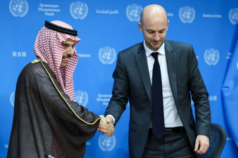 (L/R) Conference co-chairs Saudi Arabia's Foreign Minister Faisal bin Farhan al-Saud shakes hands with French Foreign Minister Jean-Noel Barrot during a press conference, at UN headquarters in New York City yesterday. 