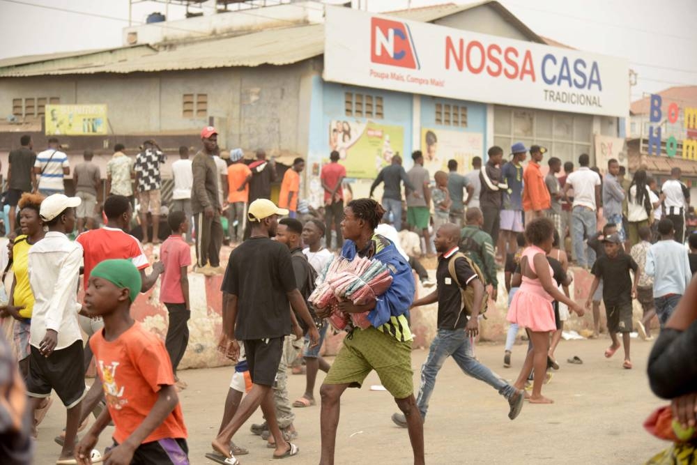 A recent photo shows a group of shops targeted as looting erupted in the Kalemba 2 district of Luanda during a general strike in the taxi sector.