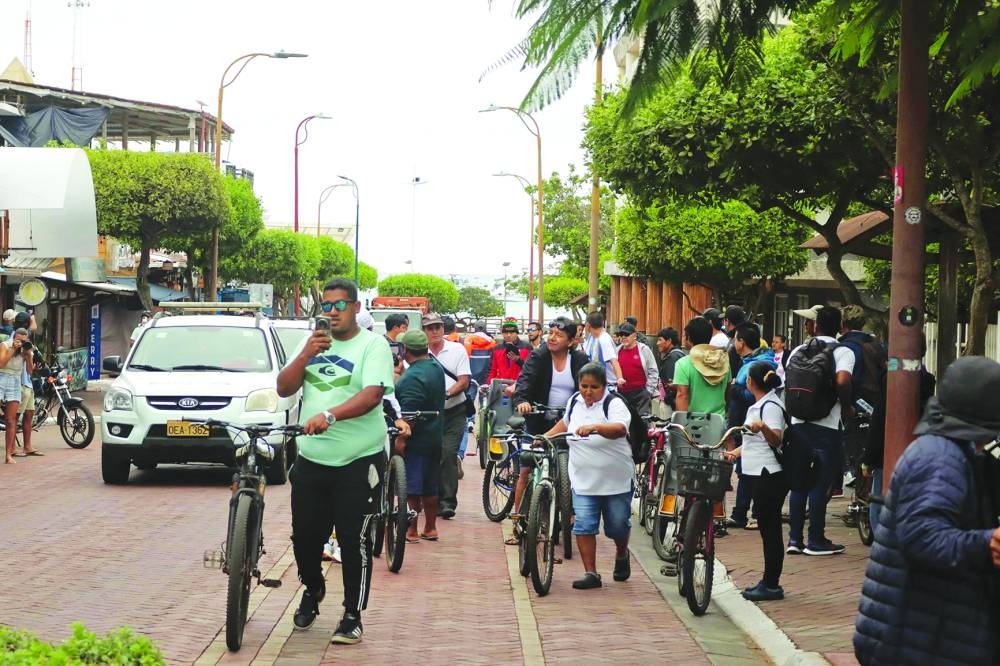 Residents evacuate to higher elevations due to a tsunami warning in Puerto Ayora, Santa Cruz Island, Galapagos, Ecuador, Wednesday.