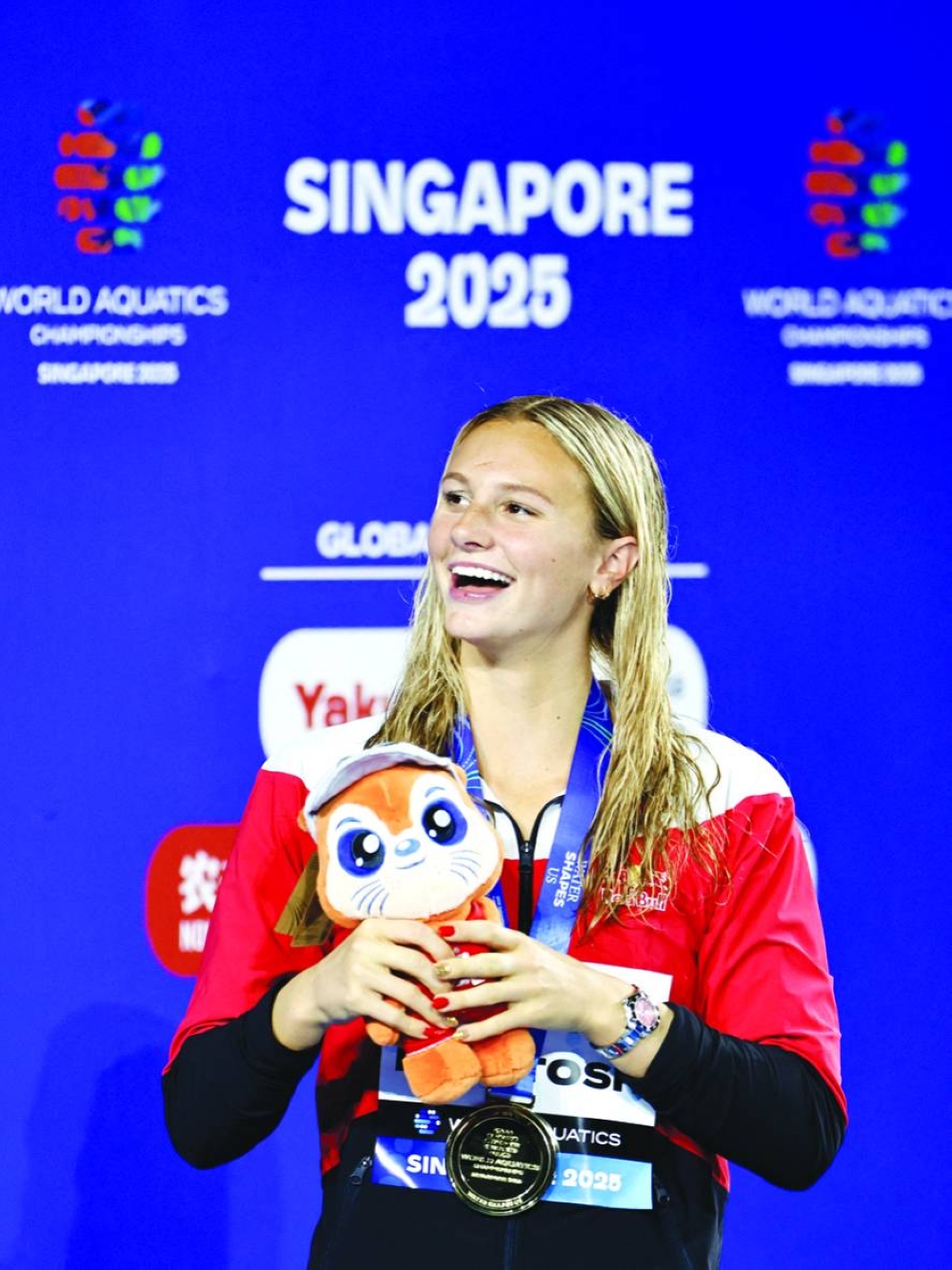 Swimming - World Aquatics Championships - Women 200m Butterfly Finals - World Aquatics Championships Arena, Singapore - July 31, 2025 Gold medallist Canada's Summer McIntosh celebrates on the podium REUTERS/Tingshu Wang