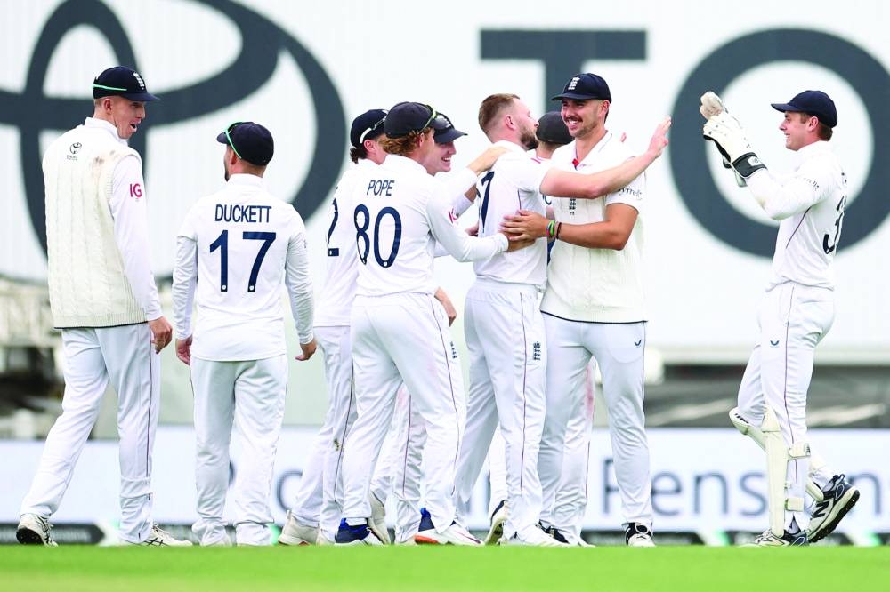 England’s Gus Atkinson is mobbed by teammates after running out India’s captain Shubman Gill Thursday. (AFP)