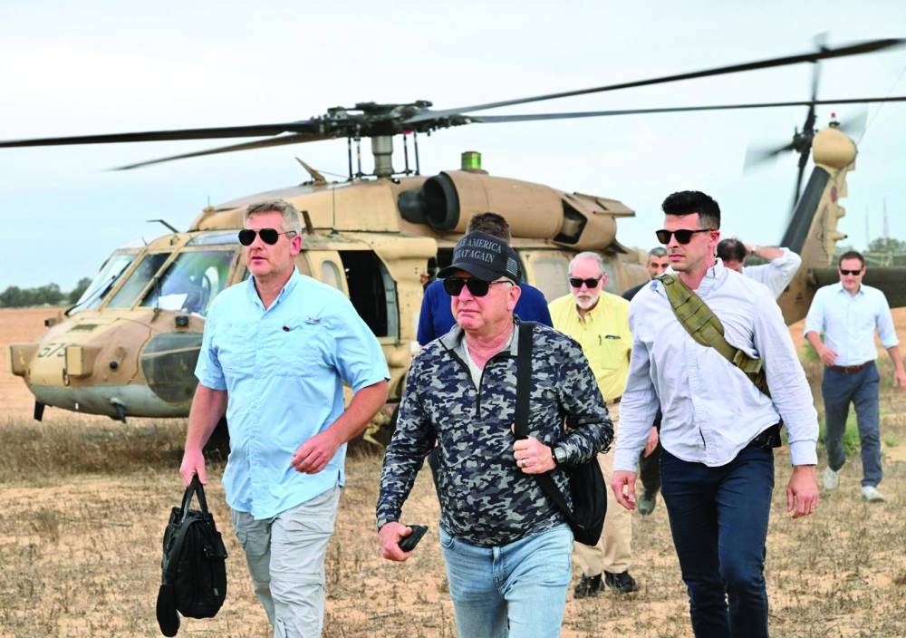 
White House special envoy to the Middle East Steve Witkoff (centre, in hat) visiting a Gaza Humanitarian Foundation food and aid distribution site inside the Gaza Strip yesterday. 