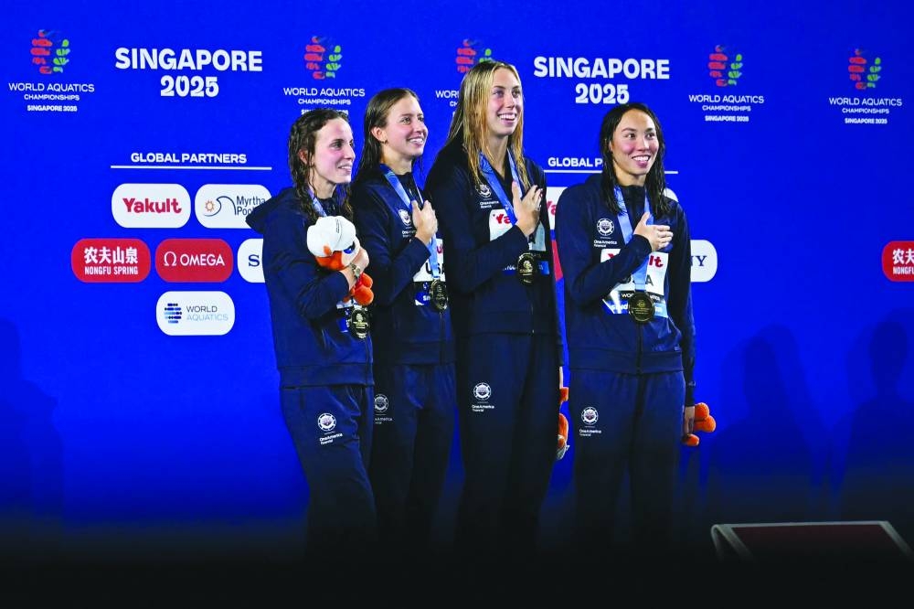 USA’s Regan Smith, Kate Douglass, Gretchen Walsh, Torri Huske pose on the podium after winning the women’s 4x100m medley relay Sunday. (AFP)