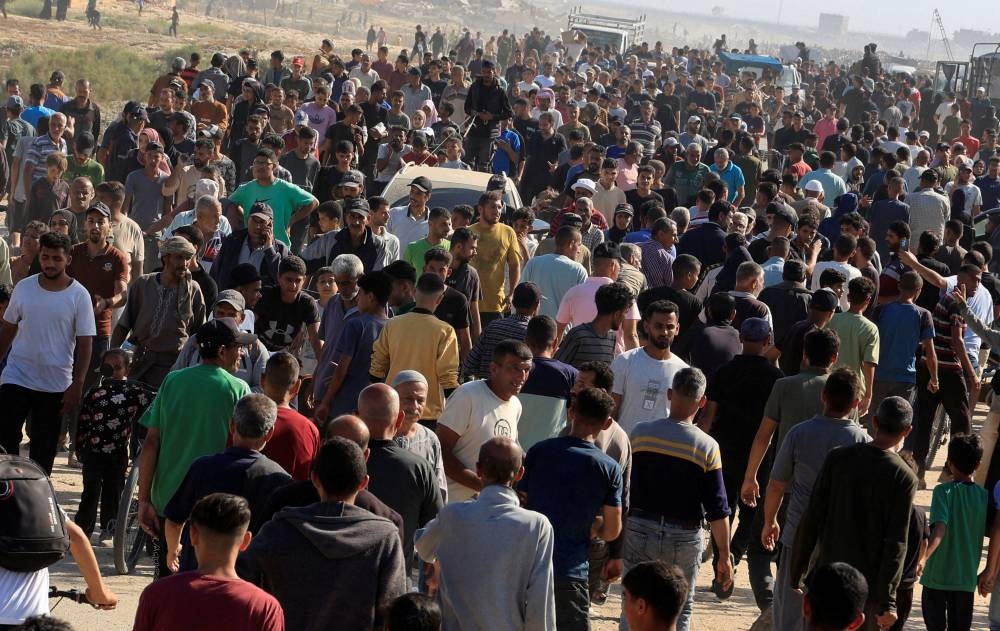 Palestinians seeking aid gather near an aid distribution site run by the US-backed Gaza Humanitarian Foundation, in Rafah, in the southern Gaza Strip, on Tuesday. REUTERS