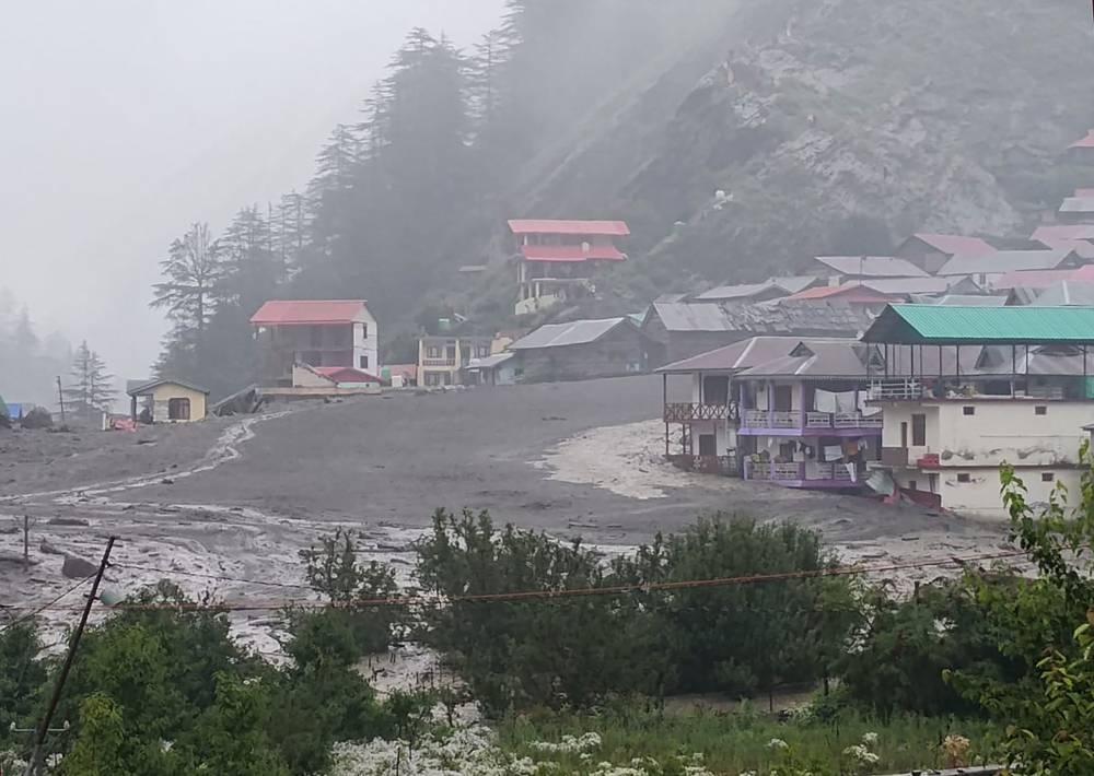 This handout photograph taken on August 5, 2025 and released by Uttarakhand's State Disaster Response Force (SDRF) shows muddy water running past residential buildings following a massive mudslide in India's Uttarakhand state. Rescue teams were deployed on Tuesday. AFP/ Uttarakhand's SDRF