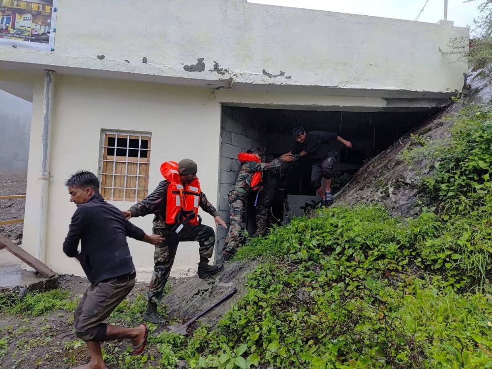 Rescuers assist people, amid flash floods, in a location given as Dharali, Uttarakhand, India, in this handout image released on Tuesday. Indian Army Central Command/Handout via REUTERS