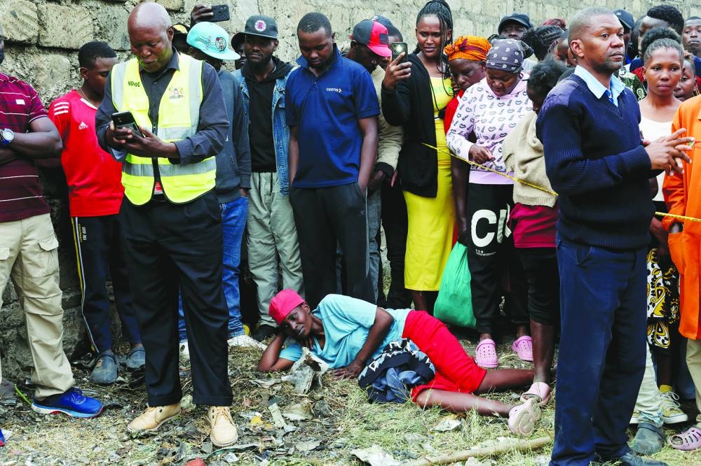 Emergency personnel work at the scene where a Cessna plane operated by AMREF Flying Doctors crashed into buildings in the Githurai suburb of northeastern Nairobi, Kenya