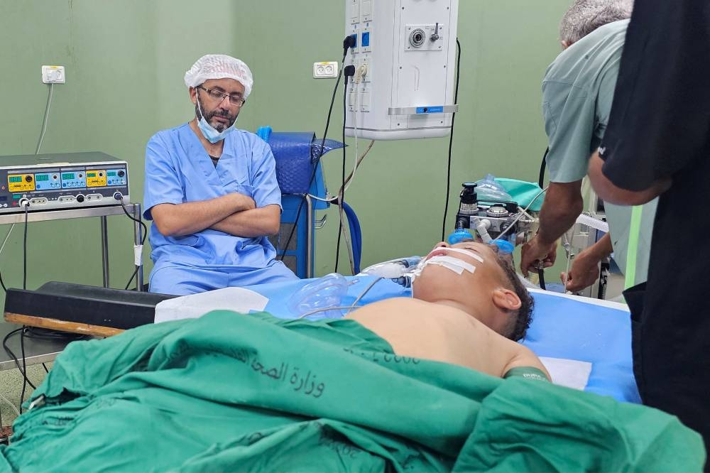 A young patient lies on the operating table in a surgical operating theatre at Nasser Medical Complex in Khan Yunis in the southern Gaza Strip, on Saturday. AFP