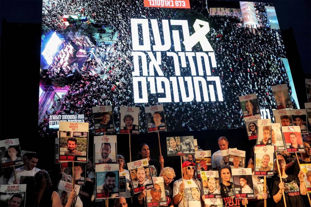 Protesters gather in a demonstration organised by the families of the Israeli hostages taken captive in the Gaza Strip since the October 2023 calling for action to secure their release in the plaza outside the Tel Aviv Museum of Art, known as the "Hostages' Square", in Tel Aviv on Saturday. AFP