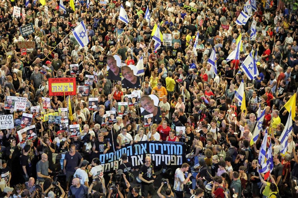 Protesters gather in a demonstration organised by the families of the Israeli hostages taken captive in the Gaza Strip since the October 2023 calling for action to secure their release outside the Defence Ministry headquarters in Tel Aviv on Saturday. AFP