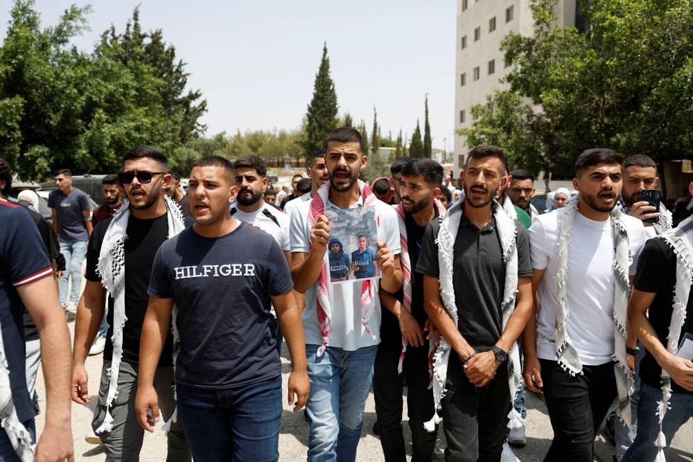 Palestinians protest against the killing of journalists in Gaza, at Birzeit University near Ramallah in the occupied West Bank, Monday.