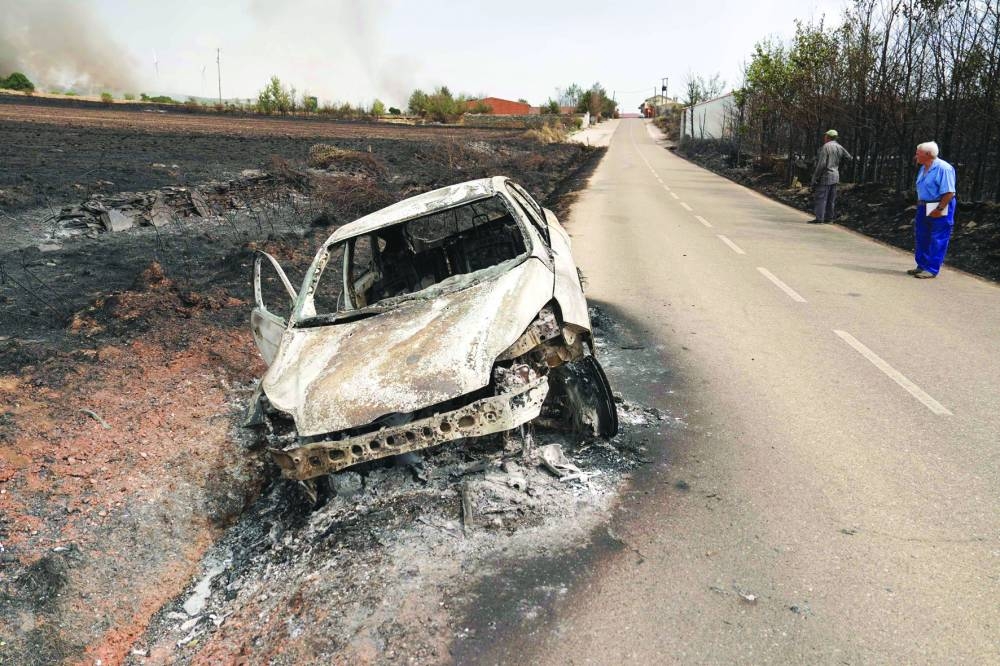 A burned car is seen in the village of Abejera, Zamora province, Spain. (AFP)