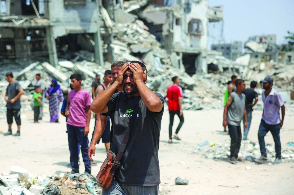 A man reacts as medics transport casualties of Israeli strikes on members of aid security committees set up by volunteers from prominent Palestinian families to prevent aid theft, in the Saftawi neighbourhood west of Jabalia in the northern Gaza Strip Wednesday.