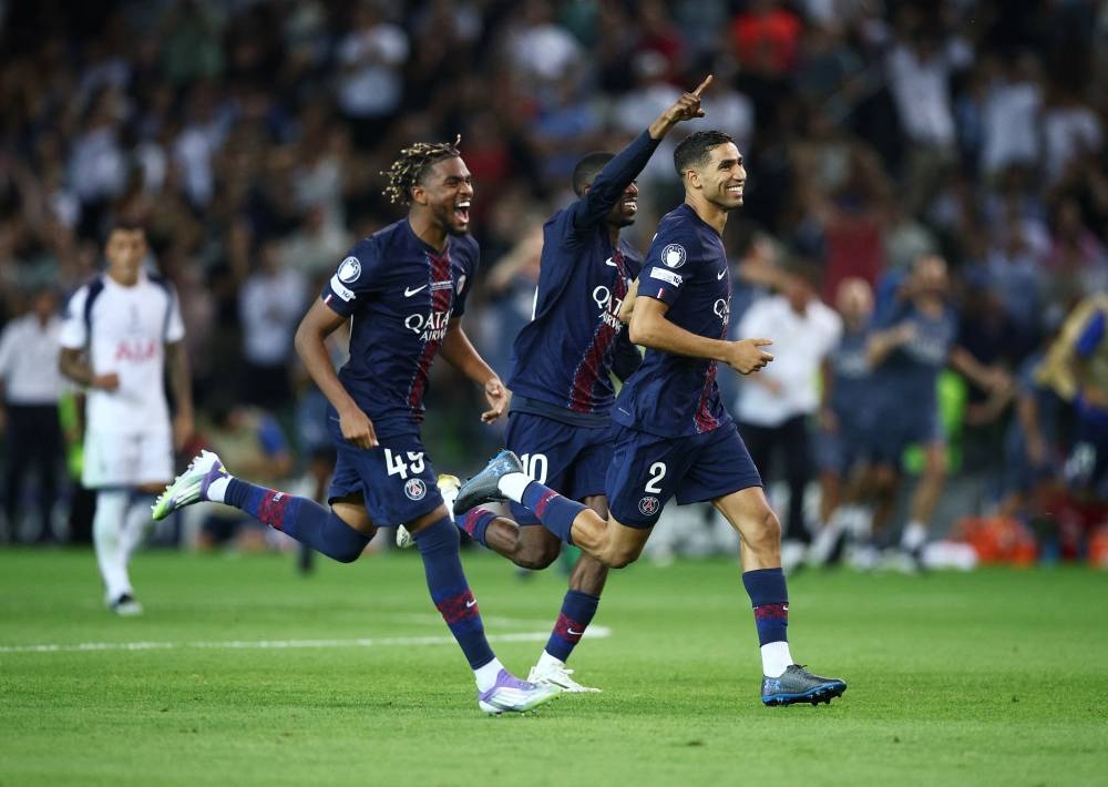 Paris Saint Germain's Noham Kamara, Ousmane Dembele and Achraf Hakimi celebrate after winning the UEFA Super Cup. REUTERS