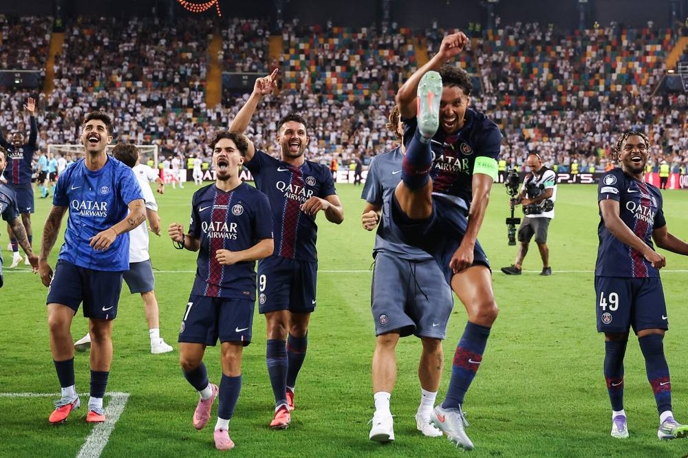 Paris Saint-Germain's Brazilian defender #05 Marquinhos (2R) celebrates with teammates after winning the 2025 UEFA Super Cup final football match between Paris Saint-Germain (FRA) and Tottenham Hotspur FC (ENG) at the Friuli stadium, in Udine,, on Wednesday. AFP