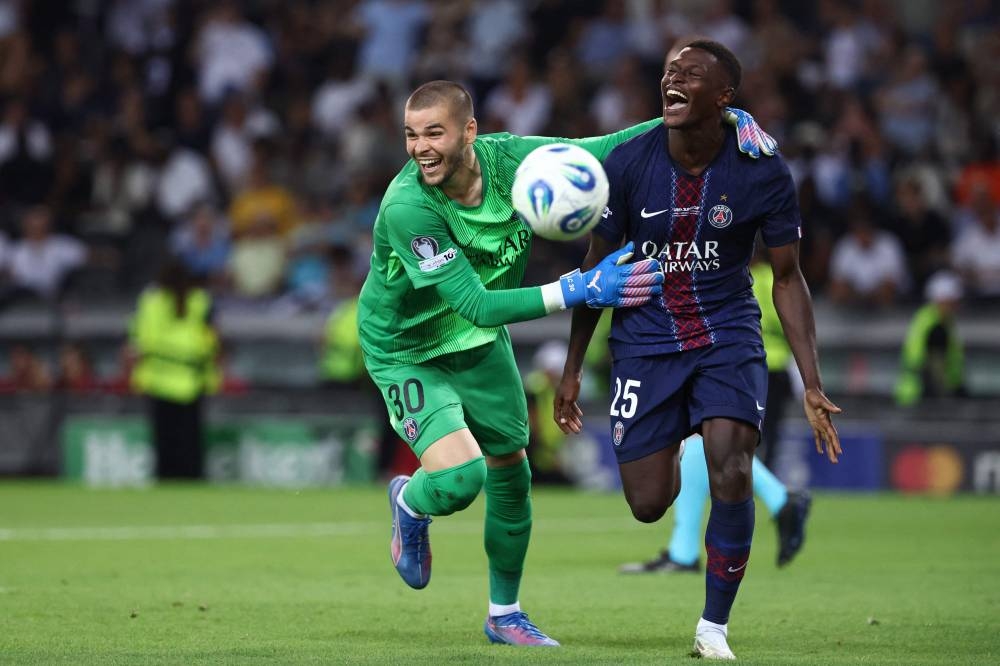  Paris Saint-Germain's Portuguese defender #25 Nuno Mendes (R) and Paris Saint-Germain's French goalkeeper #30 Lucas Chevalier (L) celebrate winning the 2025 UEFA Super Cup final football match between Paris Saint-Germain (FRA) and Tottenham Hotspur FC (ENG) at the Friuli stadium, in Udine, on Wednesday. AFP