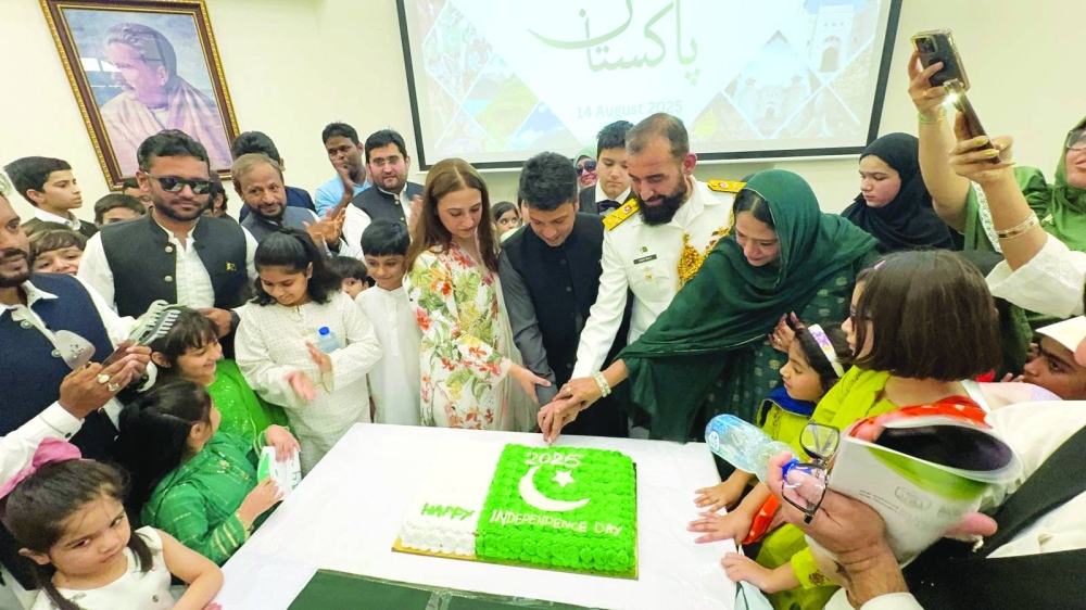 People join the cake cutting ceremony with the Chargé d’Affaires.
