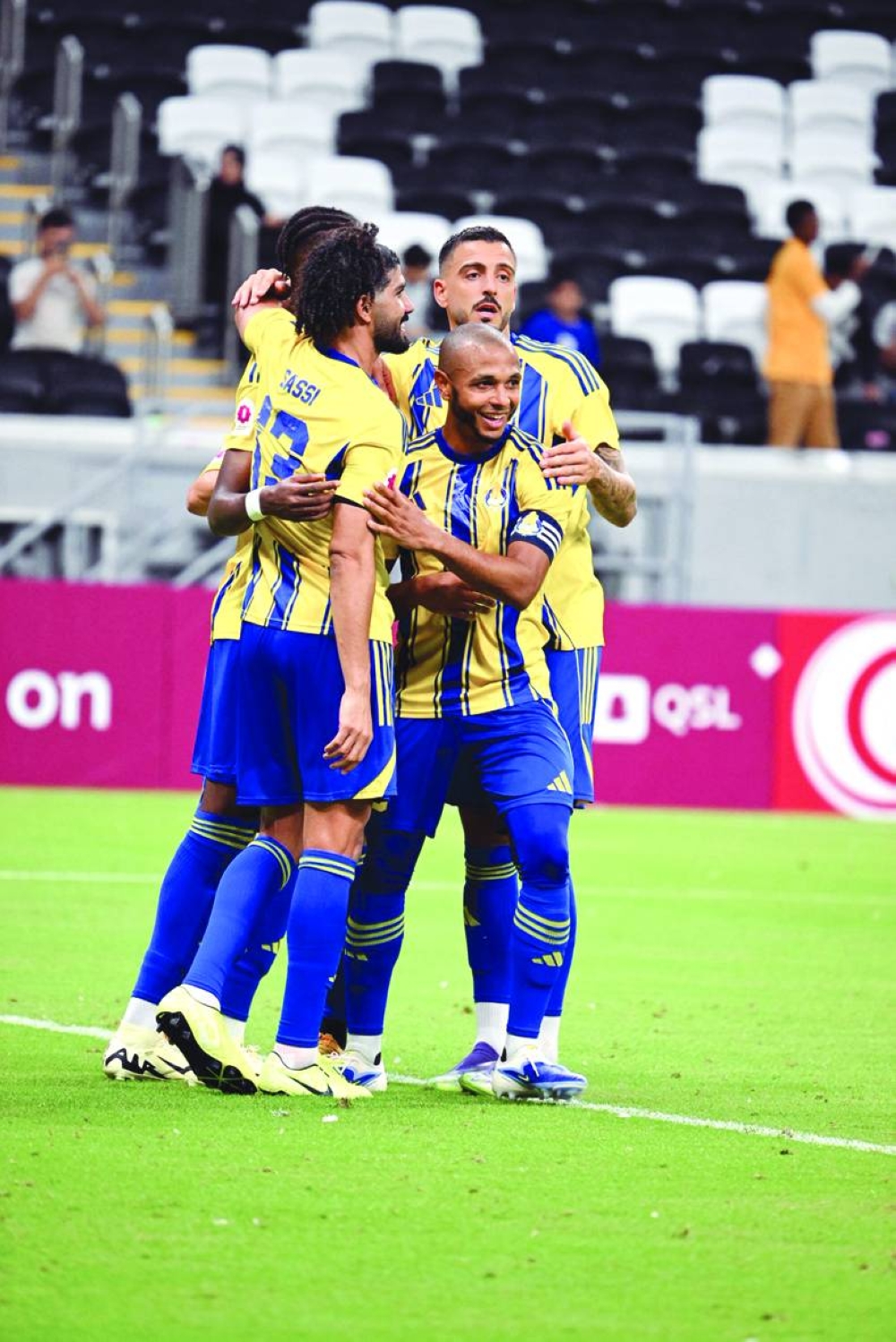 Al Gharaf captain Yacine Brahimi celebrates with teammates after their victory over Umm Salal in the QSL match at Al Bayt Stadium Friday.