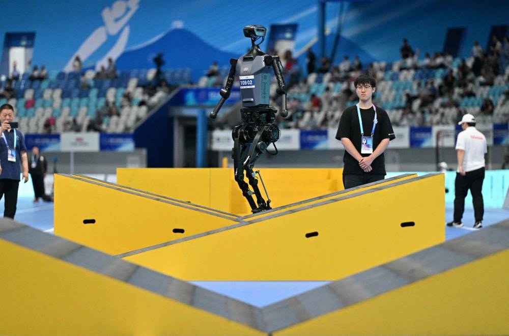 A robot competes in the 100M obstacles game event during the World Humanoid robots games in Beijing on August 16, 2025. (AFP)