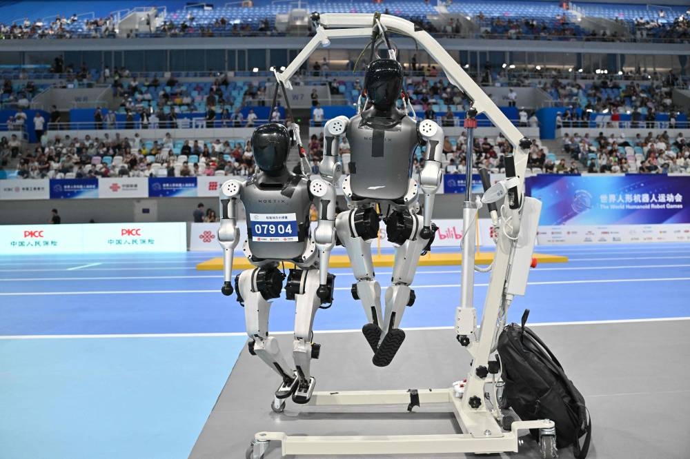 Robots are seen prior to competiting in the World Humanoid robots games in Beijing on August 16, 2025. (AFP)