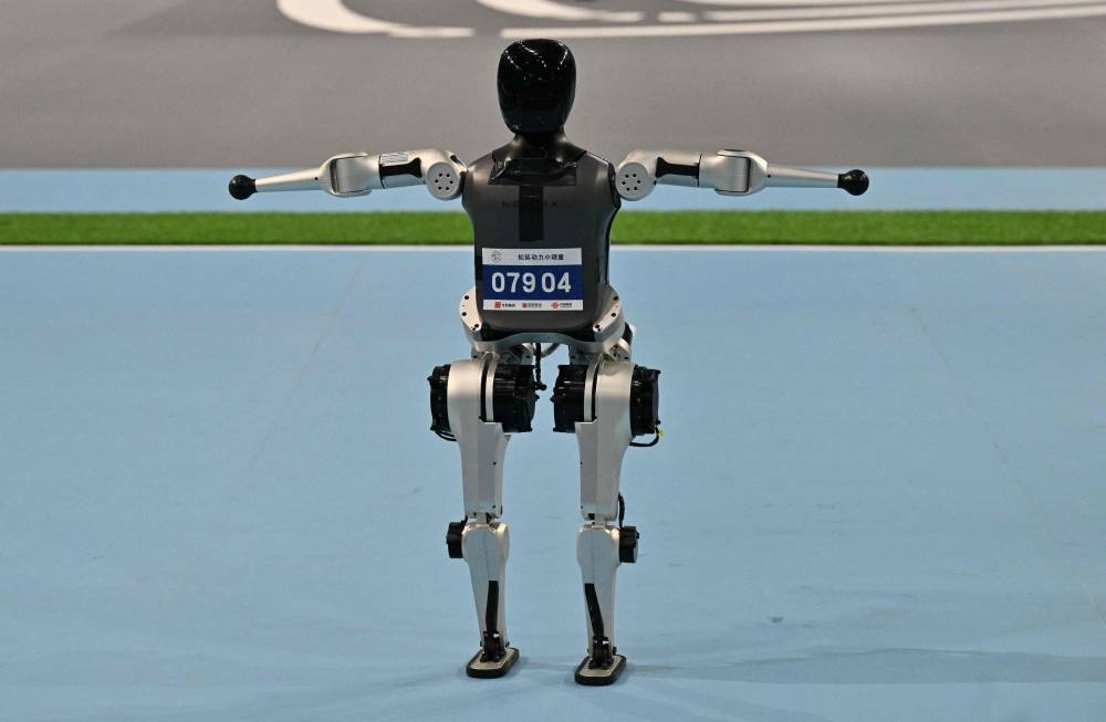A robot competes in a martial arts sport event during the World Humanoid robots games in Beijing on August 16, 2025. (AFP)