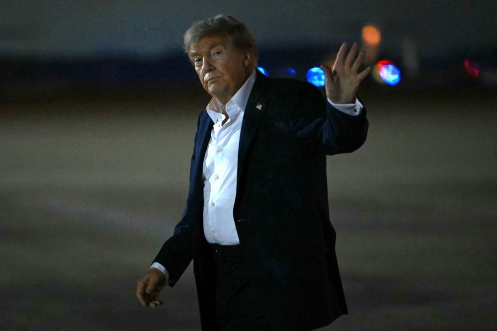 US President Donald Trump waves upon arrival at Joint Base Andrews in Maryland, on Saturday. AFP