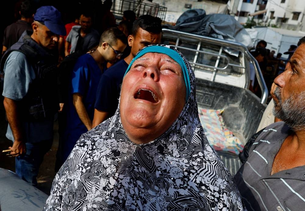 A mourner reacts during the funeral of Palestinians killed in Israeli fire while seeking aid on Friday, according to medics, at Al-Shifa Hospital, in Gaza City, on Saturday. REUTERS