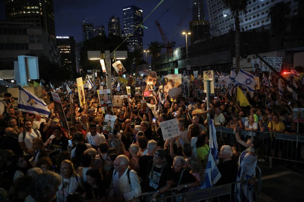 Demonstrators take part in a protest, after families of hostages have called for a nationwide strike to demand the return of all hostages and an end to the war in Gaza, in Tel Aviv, on Sunday. REUTERS