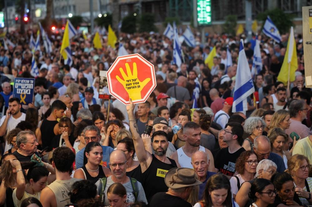 Demonstrators take part in a protest, after families of hostages have called for a nationwide strike to demand the return of all hostages and an end to the war in Gaza, in Tel Aviv, on Sunday. REUTERS