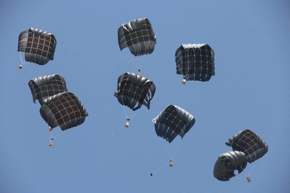 Aid packages, dropped from an airplane, descend over Gaza, in Deir Al-Balah, in the central Gaza Strip August 19, 2025. (REUTERS)