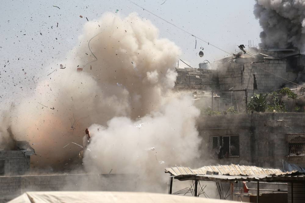 Smoke billows after an Israeli strike on a building in Jabalia in the northern Gaza Strip on August 20, 2025. (AFP)