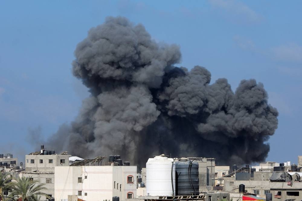 Smoke rises following an Israeli strike, in Deir Al-Balah, in the central Gaza Strip, August 23, 2025. REUTERS