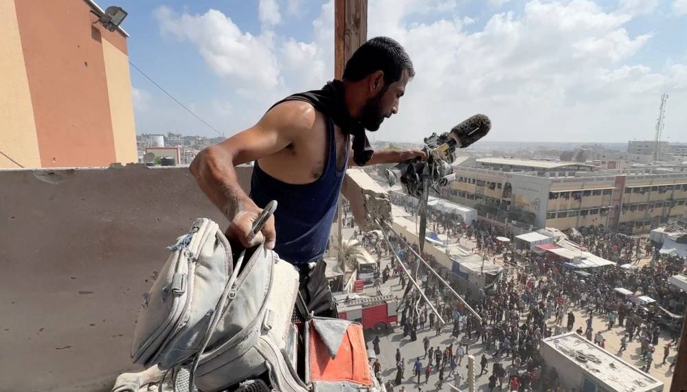 A man holds the equipment used by Palestinian cameraman Hussam al-Masri, who was a contractor for Reuters, at the site where he was killed along with other journalists and people in Israeli strikes on Nasser hospital, in Khan Younis in the southern Gaza Strip, in this still image taken from a video shot by Reuters contractor Hatem Khaled, who was wounded shortly afterwards in another strike while he was filming the site, August 25, 2025. (REUTERS)