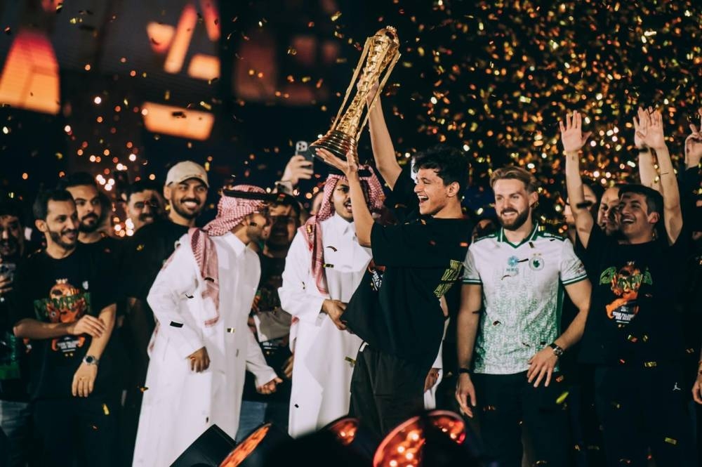 Members of Team Falcons lift the EWC Club Championship trophy after winning the Esports World Cup 2025.