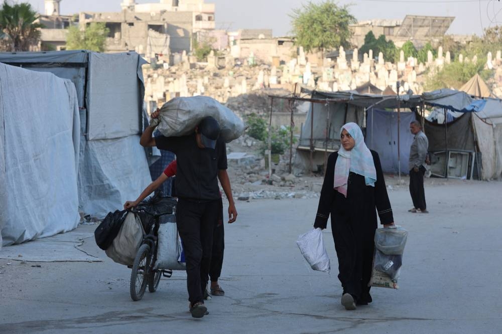 Palestinians arrive in Gaza City after fleeing their homes in the Zeitoun neighbourhood on August 26, 2025. (AFP)