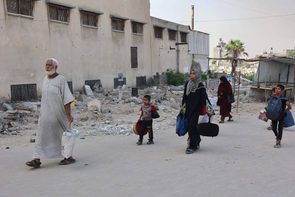 Palestinians arrive in Gaza City after fleeing their homes in the Zeitoun neighbourhood on August 26, 2025. (AFP)