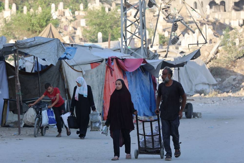 Palestinians arrive in Gaza City after fleeing their homes in the Zeitoun neighbourhood on August 26, 2025. (AFP)