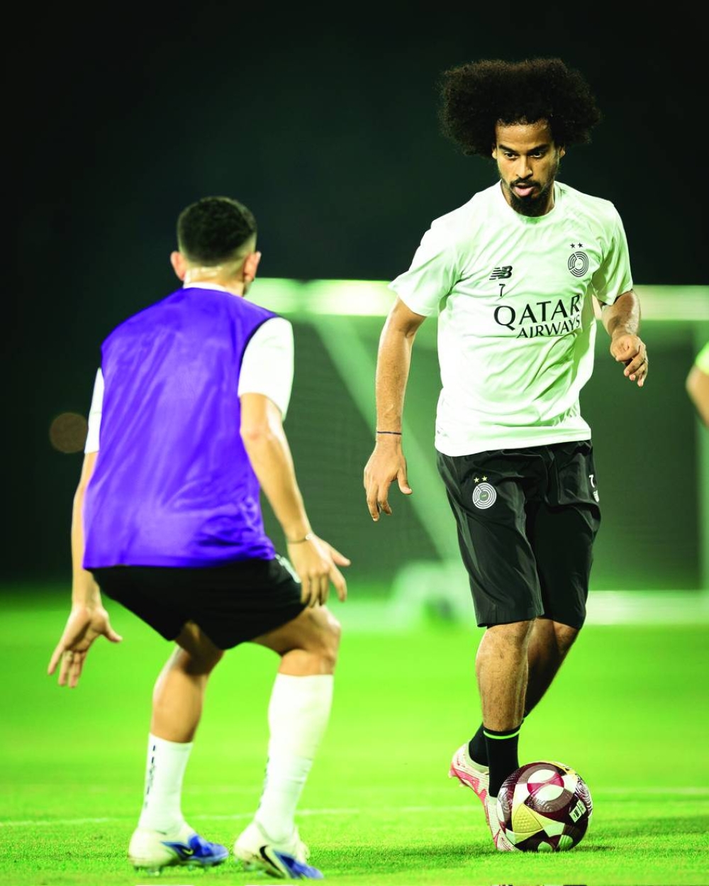 Al Sadd’s striker Akram Afif and goalkeeper Mishal Barsham (below) during their training session Wednesday.