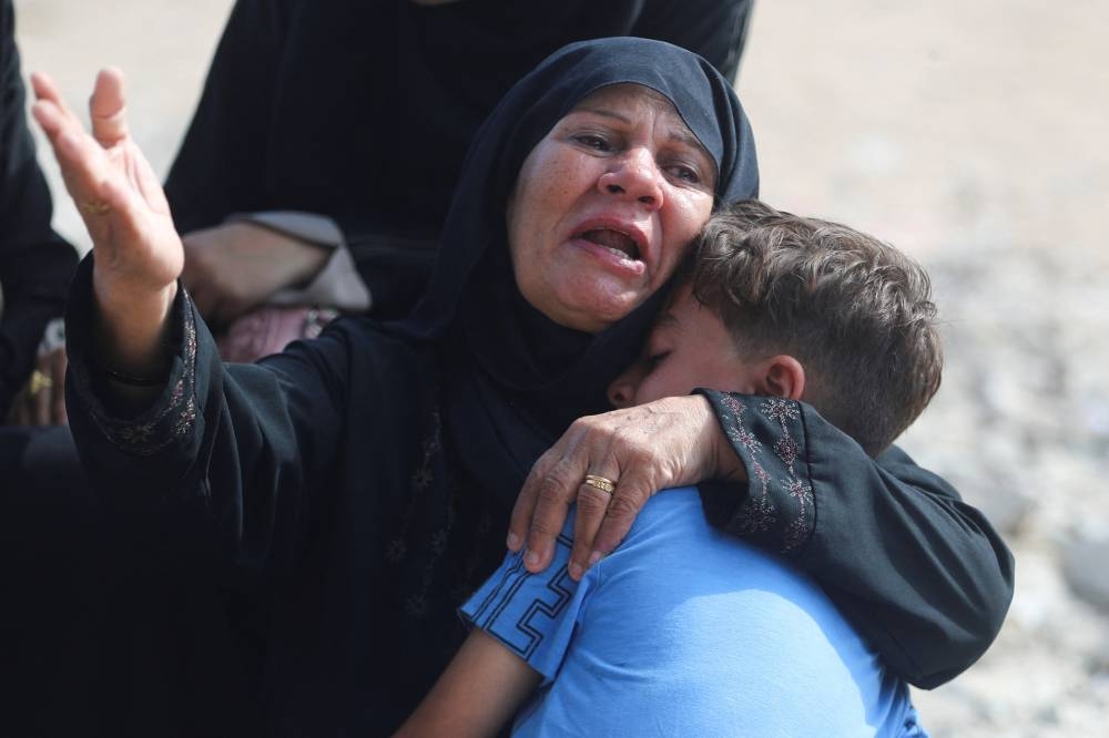 A mourner reacts during the funeral of Palestinians killed in Israeli fire, according to medics, at Al-Shifa hospital, in Gaza City, August 28, 2025. REUTERS