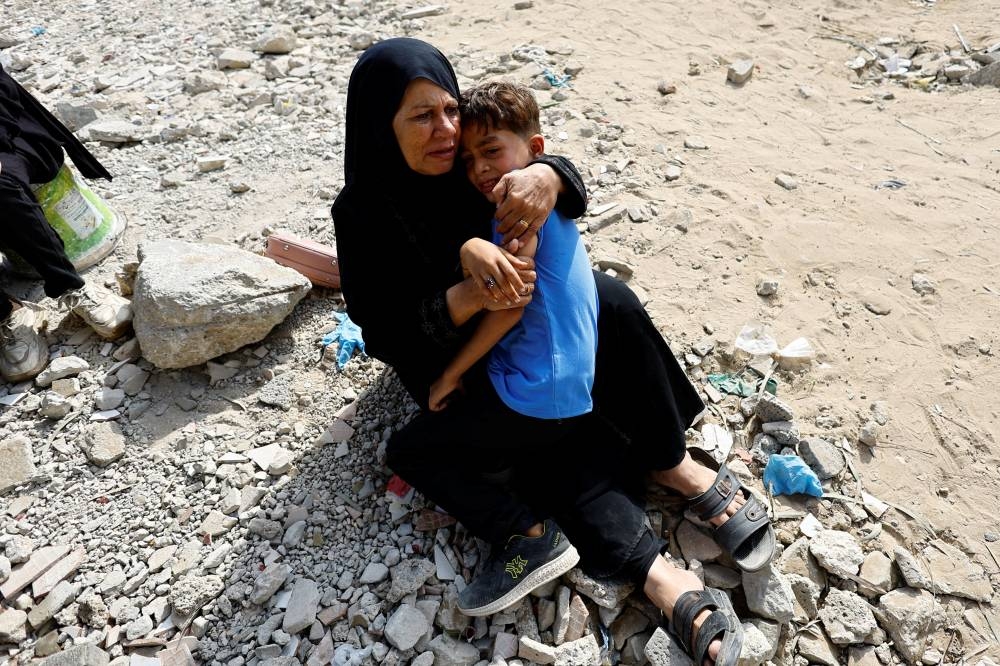 Mourners react during the funeral of Palestinians killed in Israeli fire, according to medics, at Al-Shifa hospital, in Gaza City, August 28, 2025. REUTERS